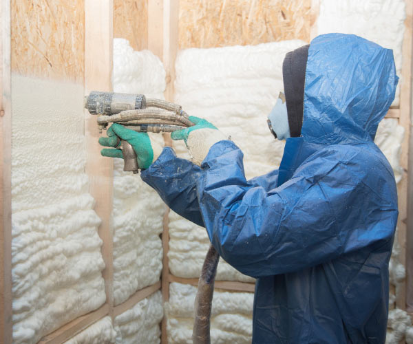 Spray foam insulation contractor, insulating home's walls.